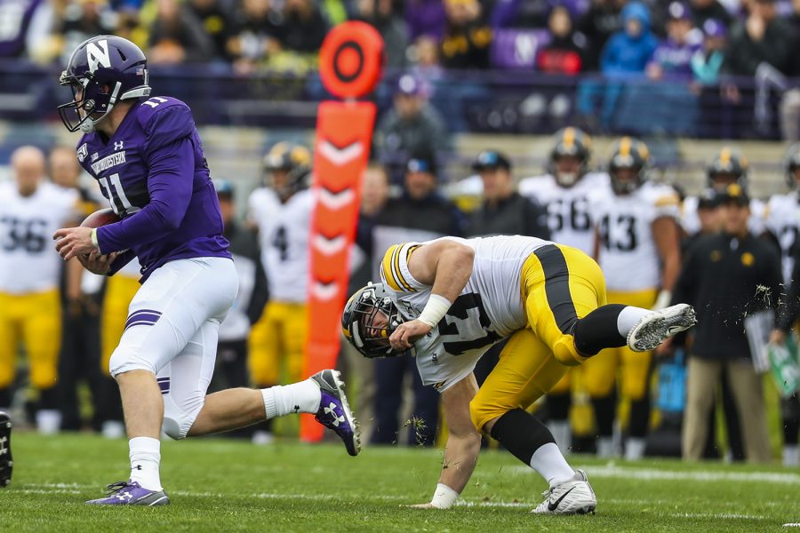 Iowa linebacker Joe Evans attempts to run after Northwestern quarterback Aiden Smith during the Iowa vs. Northwestern football game at Ryan Field on Saturday, October 26, 2019. The Hawkeyes defeated the Wildcats 20-0. 