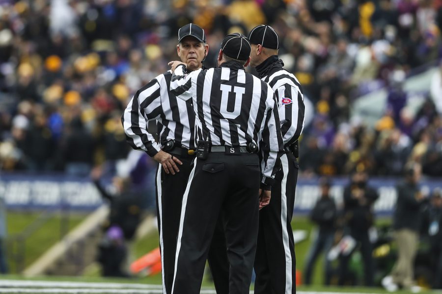 Referees discuss whether a pass thrown to Iowa tight end Sam LaPorta was completed during the Iowa vs. Northwestern football game at Ryan Field on Saturday, October 26, 2019. The pass was later ruled incomplete.