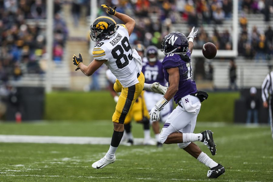 Iowa wide receiver Nico Ragaini loses the ball as Northwestern defensive back Cameron Ruiz attempts to grab it during the Iowa vs. Northwestern football game at Ryan Field on Saturday, October 26, 2019. The Hawkeyes defeated the Wildcats 20-0. Ragaini caught one pass and gained a total of four yards.