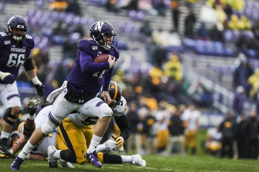 Northwestern quarterback Aiden Smith runs the ball during the Iowa vs. Northwestern football game at Ryan Field on Saturday, October 26, 2019. The Hawkeyes defeated the Wildcats 20-0. Out of the 32 attempted passes throughout the game, Smith completed 18.