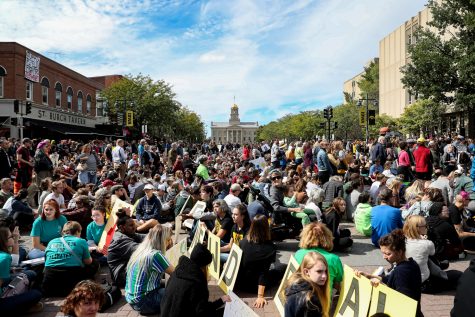 Protesters take part in an 11-minutes sit-down protest during the Iowa City Climate Strike in downtown Iowa City on Friday, Oct. 4, 2019. 