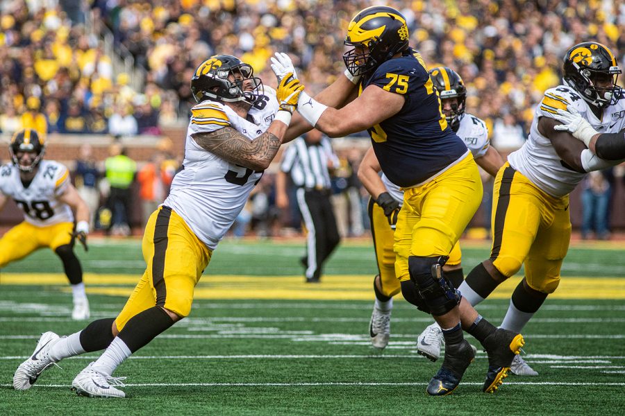 Iowa defensive end AJ Epenesa pursues the quarterback during a football game between Iowa and Michigan in Ann Arbor on Saturday, October 5, 2019. The Wolverines celebrated homecoming and defeated the Hawkeyes, 10-3. 