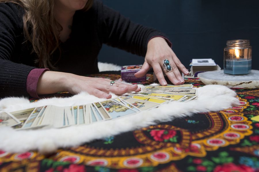 Dawn Frary shows a deck of tarot cards on Saturday, Oct. 12, 2019. Frary performed a demonstration tarot reading at Over the Moon Studio, a shared workspace downtown.  (Emily Wangen/The Daily Iowan)