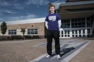 Liberty High School senior Scott Dill poses for a portrait in front of the school in North Liberty on Friday, October 18, 2019. Dill is DeGowin Blood Center’s first student to donate two gallons of blood before graduation. 