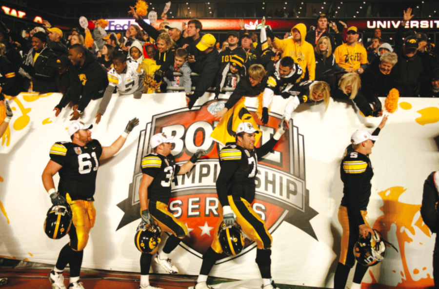 Iowa players shake fans’ hands after defeating Georgia Tech in the Orange Bowl in Miami on Jan. 5, 2010.