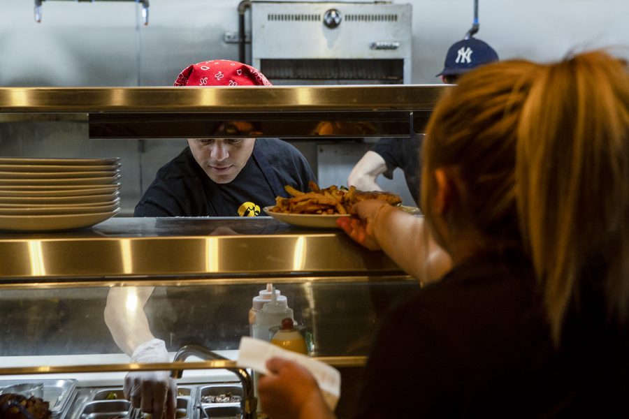 A server retrieves a dish from the kitchen at the Marion location of Short’s Burgers & Shine on Thursday, Oct. 24 2019. This is the first Short’s location outside of the Iowa City area.