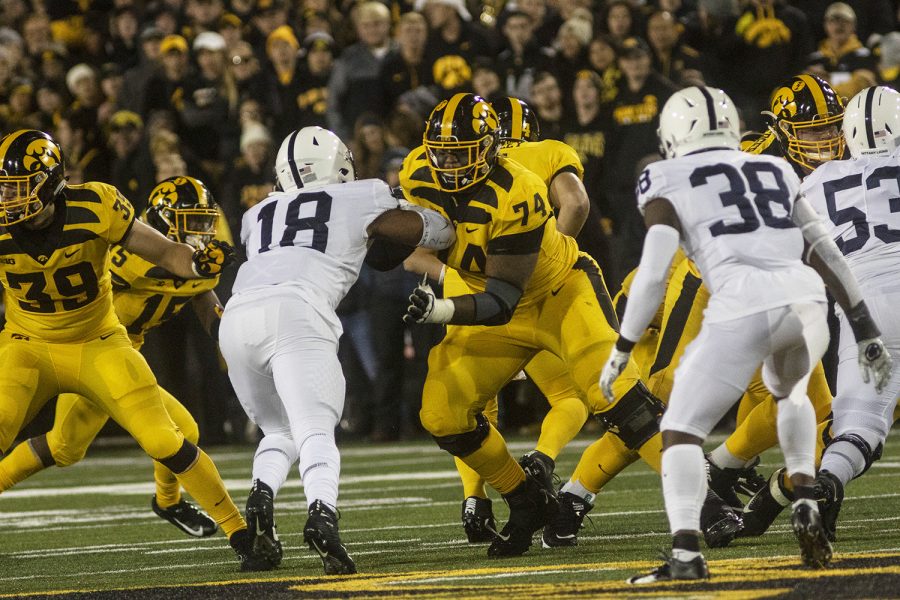 Iowa OL Tristan Wirfs defends QB Nate Stanley during the Iowa football vs. Penn State game in Kinnick Stadium on Saturday, Oct. 12, 2019. The Nittany Lions defeated the Hawkeyes 17-12.