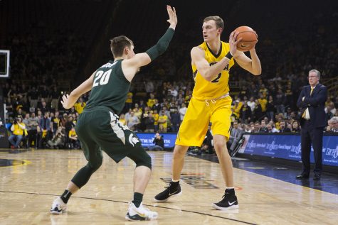Iowa F Jack Nunge faces off with Michigan State G Matt McQuaid (20) during a basketball game between Iowa and Michigan State at Carver-Hawkeye Arena on Tuesday, Feb. 6, 2018. The Hawkeyes were defeated by the visiting Spartans, 96-93. 