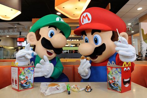In this photo provided by Nintendo of America, Mario and Luigi enjoy Happy Meals on July 12, 2014 in Los Angeles, California. Nintendo is celebrating the recently released Mario Kart 8 game for the Wii U console by partnering with McDonald's nationwide to include themed toys in Happy Meals. (Bob Riha, Jr./Nintendo of America via Getty Images/TNS)