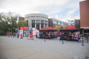 A student security worker guards the Nintendo Switch Together tour event space on the Main Library Plaza on Thursday, Oct. 3, 2019.