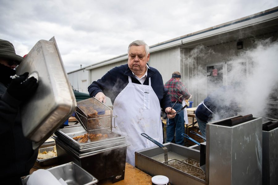 A volunteer fries fish during the first annual Finkenauer fish fry at Hawkeye Downs on Saturday, November 2, 2019.  U.S. Rep. Abby Finkenauer hosted eight presidential candidates for a fish fry focused on jobs and infrastructure.