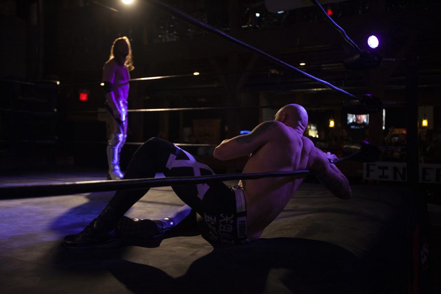 Xander Killen leans against the ropes while  Zeke Andino watches from across the ring during Hawkmania XII, a live pro-wrestling event held Saturday, Nov. 9, 2019 at Wildwood Smokehouse and Saloon. Hawkmania is part of the SCW professional wrestling league, which puts on events throughout the Eastern Iowa and Quad Cities areas. Killen eventually went on to defeat Andino. 