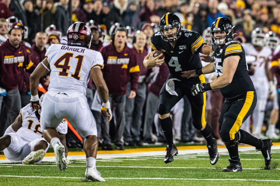 Iowa quarterback Nate Stanley carries the ball during a football game between Iowa and Minnesota at Kinnick Stadium on Saturday, Nov. 16, 2019. The Hawkeyes defeated the Gophers, 23-19. (Shivansh Ahuja/The Daily Iowan)