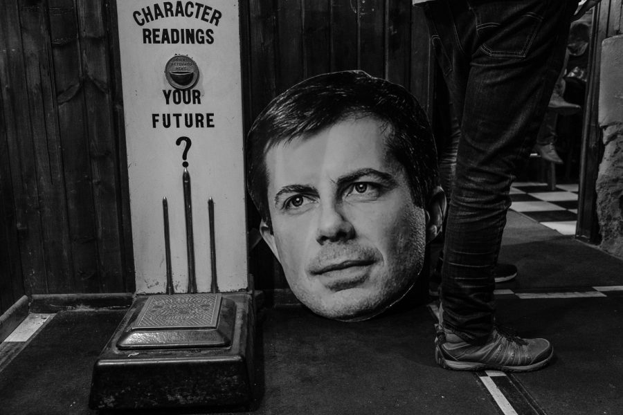 An organizer for South Bend, Ind. Mayor Pete Buttigieg watches the debate during a watch party at the Sanctuary Pub in Iowa City on Wednesday, November 20, 2019. 