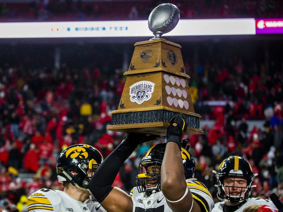 Iowa defensive lineman Chauncey Golston carries the Heroes Trophy after the football game against Nebraska at Memorial Stadium on Friday, November 29, 2019. The Hawkeyes defeated the Cornhuskers, 27-24.
