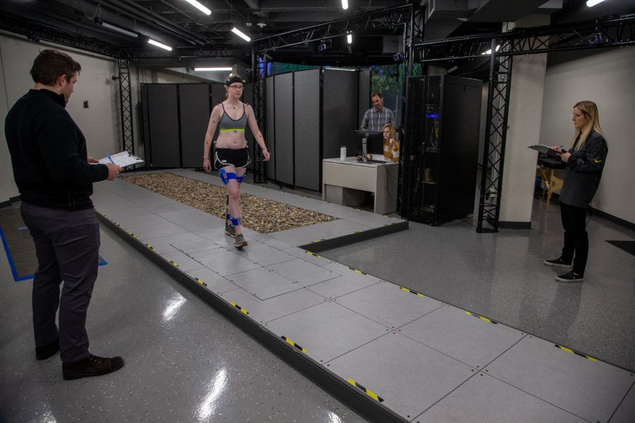 PhD+student+Kirsten+Anderson+walks+across+the+lab+during+a+computerized+gait+analysis+on+Thursday%2C+Nov.+14%2C+2019.+The+small+spheres+attached+to+her+body+are+sensors+that+cameras+see+to+make+a+computer-generated+figure.+