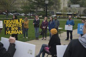 Rally attendees hold signs and listen to speakers on the Pentacrest on Wednesday, May 1, 2019. UI Students for Disability Advocacy & Awareness organized this rally to speak about the injustice that students with disabilities face on campus. (Hannah Kinson/The Daily Iowan)