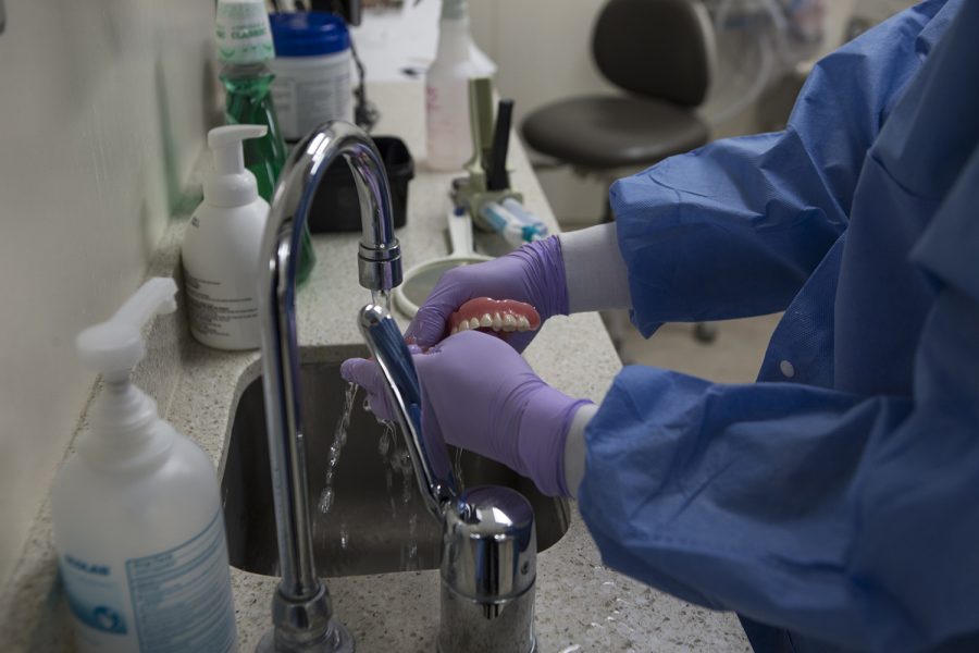 Dr. Hyunok Jo washes dentures from the College of Denistry on April 11, 2019. The College of Dentistry has been giving free dentures to veterans in the community. A regular set of dentures is around $2500 and are typically not covered by dental insurance through the VA. 
