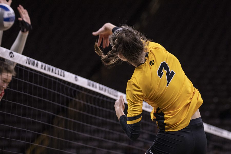 Iowa outside hitter Courtney Buzzerio spikes a ball towards the Ohio side of the net during a volleyball match between the University of Iowa and Ohio State University at Carver Hawkeye Arena on Friday, November 29, 2019. The Buckeyes defeated the Hawkeyes 3-1.