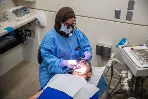 Dr. Alshimaa Alghamdi performs a cleaning on her patient at the Operative Dentistry Clinic on Wednesday November 20, 2019. (Megan Nagorzanski/The Daily Iowan)