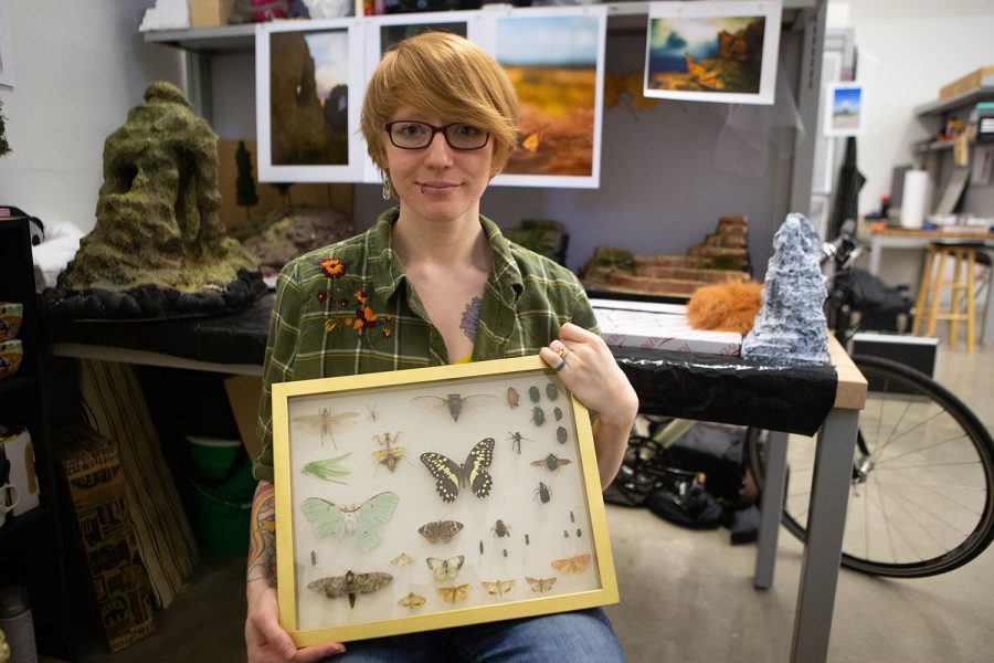Neva Nobles-Alder poses for a portrait with part of her collection of bugs on Tuesday, Nov. 5, 2019. She uses these bugs, which she acquires post mortem, along with other three-dimensional art to make photographs. Nobles-Alder is a graduate student at the University of Iowa studying photography and book arts.