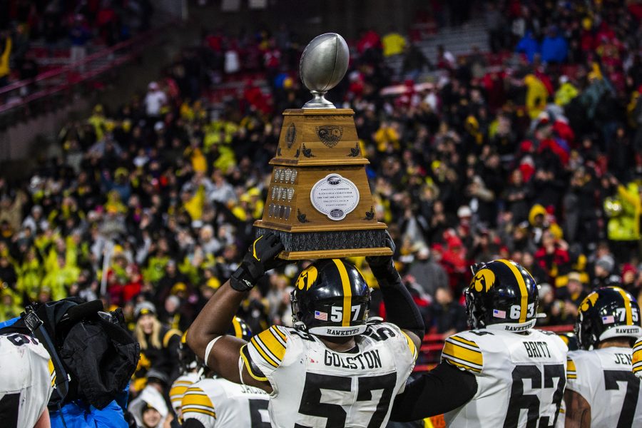 Iowa defensive lineman Chauncey Golston carries the Heroes Trophy during the football game against Nebraska at Memorial Stadium on Friday, November 29, 2019. The Hawkeyes defeated the Cornhuskers 27-24. (Katina Zentz/The Daily Iowan)