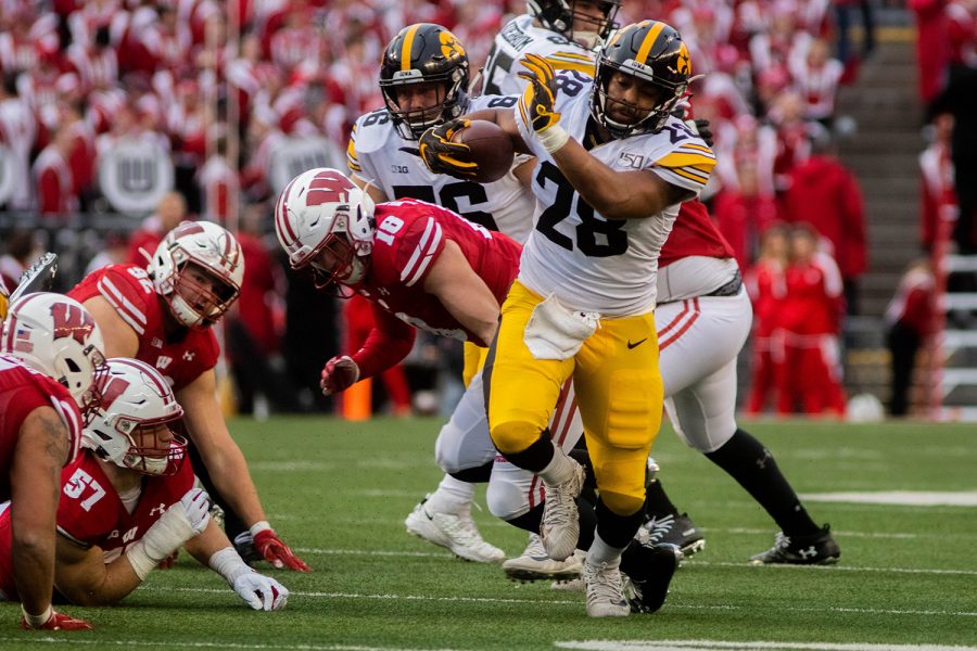 Iowa running back Toren Young breaks a tackle during a game against Wisconsin at Camp Randall Stadium on Saturday, November 9, 2019. The Hawkeyes were defeated by the Badgers 24-22. Young ran for a total of 44 yards.  