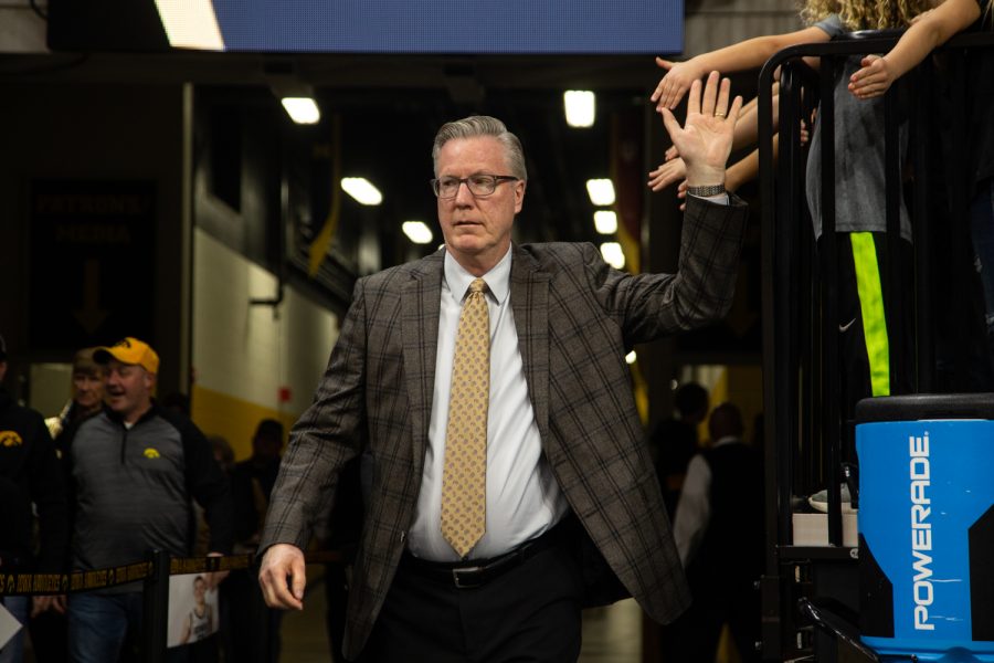 Iowa Mens Basketball head coach Fran McCaffery gives high fives to young Hawkeye fans as he exits the tunnel to the court before a basketball game against Kennesaw State University on Sunday, Dec. 29, 2019 at Carver Hawkeye Arena. The Hawkeyes defeated the Owls, 93-51. McCaffery was named the 22nd head coach for the team in 2010.