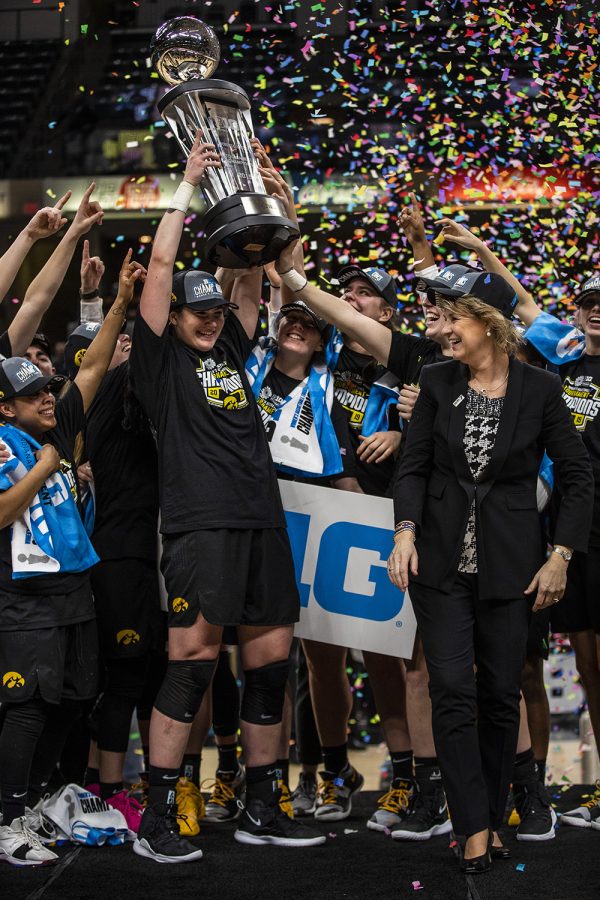 Iowa center Megan Gustafson holds up the Big Ten Trophy to  celebrate the win during the women's Big Ten Championship basketball game vs. Maryland at Bankers Life Fieldhouse on Sunday, March 10, 2019. The Hawkeyes defeated the Terrapins 90-76 and are the Big Ten champions. 