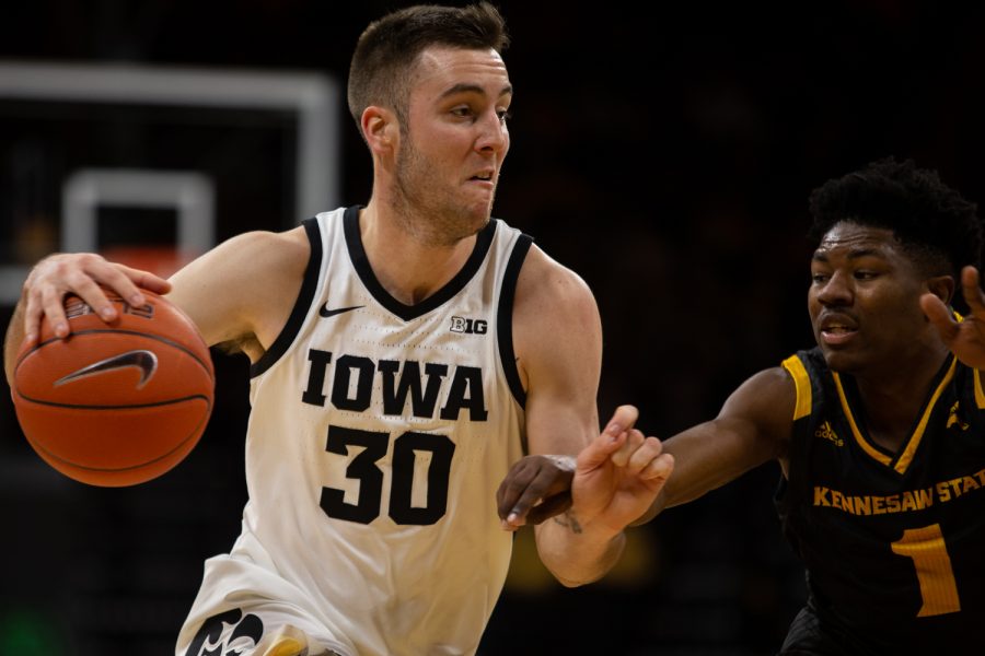 Iowa guard Connor McCaffery keeps the ball away from Kennesaw State guard Terrell Burden during a basketball game against Kennesaw State University on Sunday, Dec. 29, 2019 at Carver Hawkeye Arena. The Hawkeyes defeated the Owls, 93-51. (Emily Wangen/The Daily Iowan)