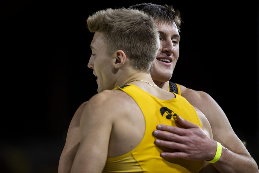 Iowa’s Austin West and Spencer Gudgel congratulate each other on a second place finish in the 4x400m relay during the Jimmy Grant Invitational at the University of Iowa Recreation Building on Saturday, Dec. 14, 2019.