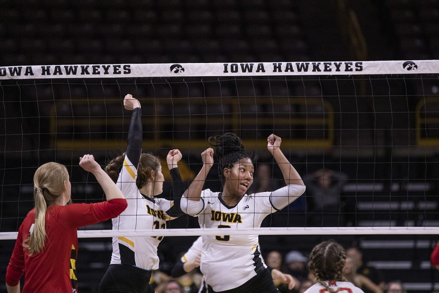 Iowa middle blockers Amiya Jones and Blythe Rients celebrate a point during a volleyball match between the University of Iowa and University of Maryland at Carver Hawkeye Arena on Saturday, November 30, 2019.  The Hawkeyes defeated the Terrapins 3-1.