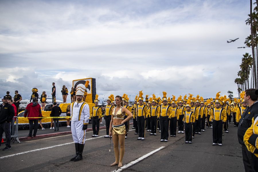 The Hawkeye Marching Band prepares to walk in the during the Thursday, December 26, 2019. Members of the community and fans gathered to watch the floats and performances by bands from Iowa and around the area.