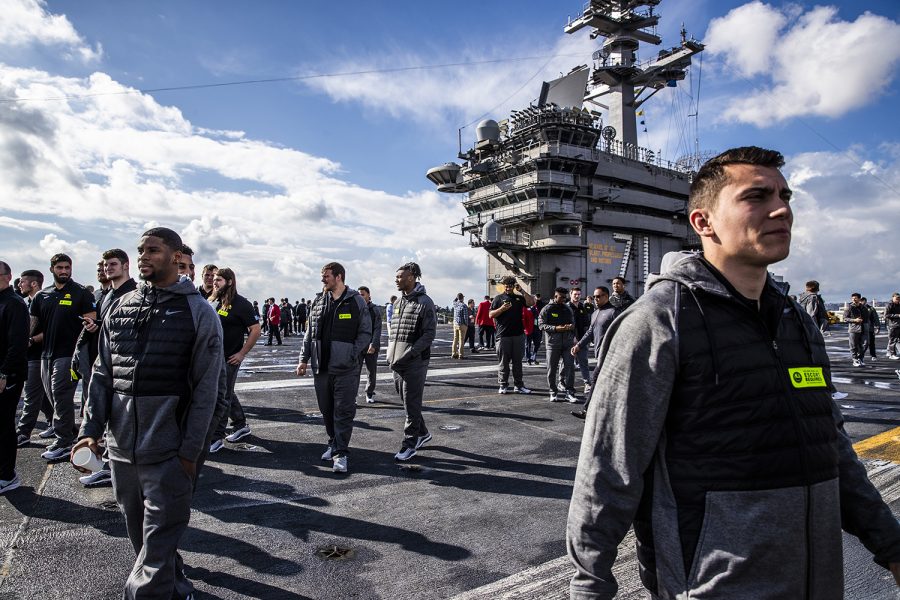 Iowa players reach the top of the ship during the tour of the U.S.S. Theodore Roosevelt at the U.S. Naval Base San Diego in San Diego, Calif. on. Tuesday, December 24, 2019. Both Iowa and Southern California toured the ship and were escorted by Navy personnel.