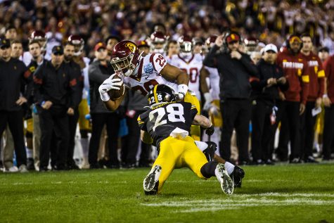 Iowa defensive back Jack Koerner tackles USC tailback Vavae Malepeai during the Holiday Bowl game between Iowa and USC at SDCCU Stadium on Friday, Dec. 27, 2019. The Hawkeyes defeated the Trojans, 49-24.