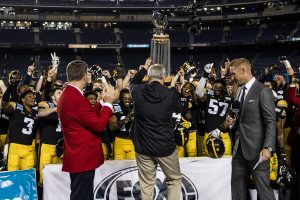 Iowa head coach Kirk Ferentz presents the trophy after the Holiday Bowl game between Iowa and USC at SDCCU Stadium on Friday, Dec. 27, 2019. The Hawkeyes defeated the Trojans, 49-24.