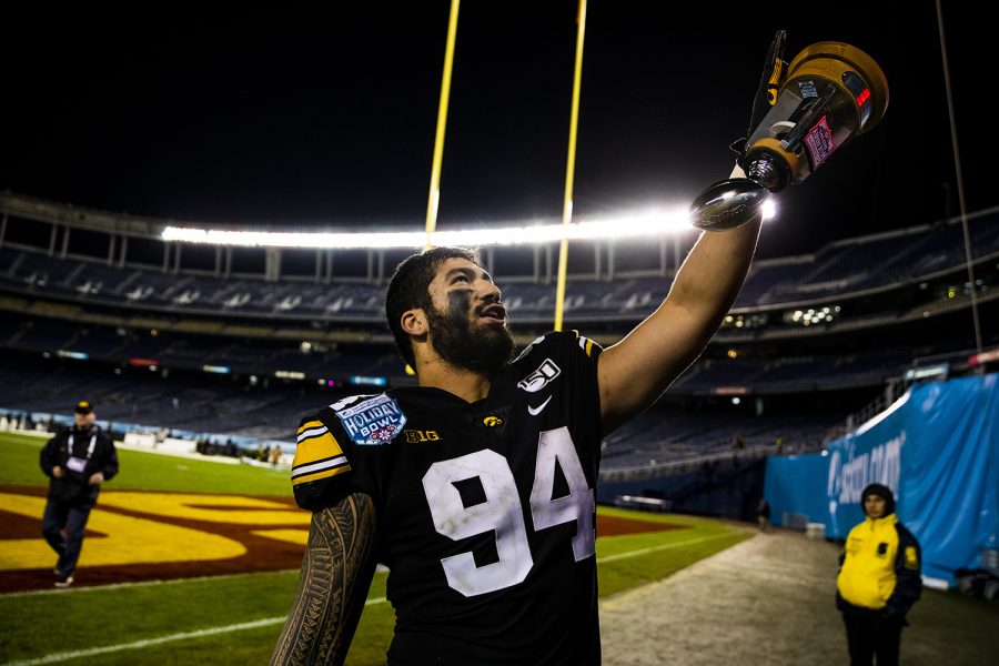 Iowa defensive end A.J. Epenesa displays his Defensive MVP award to his family during the Holiday Bowl game between Iowa and USC at SDCCU Stadium on Friday, Dec. 27, 2019. The Hawkeyes defeated the Trojans, 49-24.