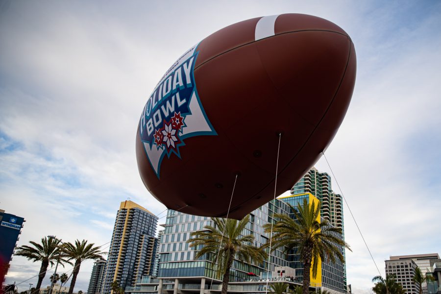 The Holiday Boal float flies down Harbor St. during the 2019 Holiday Bowl Parade in San Diego on Thursday, Dec. 26, 2019.