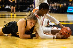 Iowas Monika Czinano and Clemsons Tylar Bennett reach for the ball during a women’s basketball match between Iowa and Clemson at Carver-Hawkeye Arena on Wednesday, Dec. 4, 2019. The Hawkeyes defeated the Tigers, 74-60.