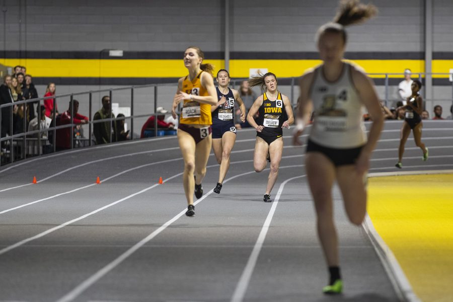 Iowa mid distance runner Lindsay Welker pushes down the home stretch of the women’s 600m run as teammate Mika Cox rounds the corner behind her during the fourth annual Larry Wieczorek Invitational at the University of Iowa Recreation Building on Friday, Jan. 17, 2020. 
