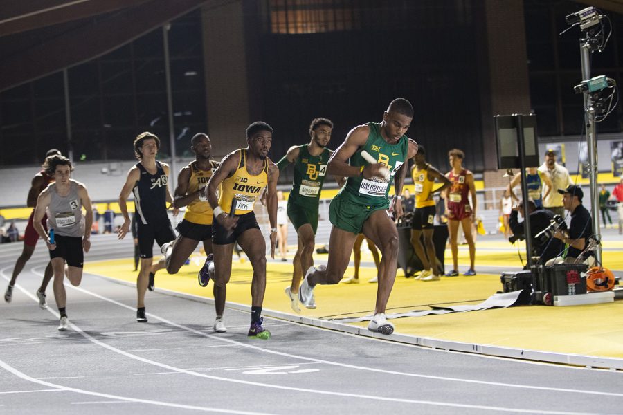 Iowa sprinter DeJuan Frye takes off on the third leg of the 4x400m relay premier during the Larry Wieczorek Invitational at the University of Iowa Recreation Building on Jan. 18, 2020. Britt, Woodard, Frye, and Lawrence took second with a combined time of 3:10.36.