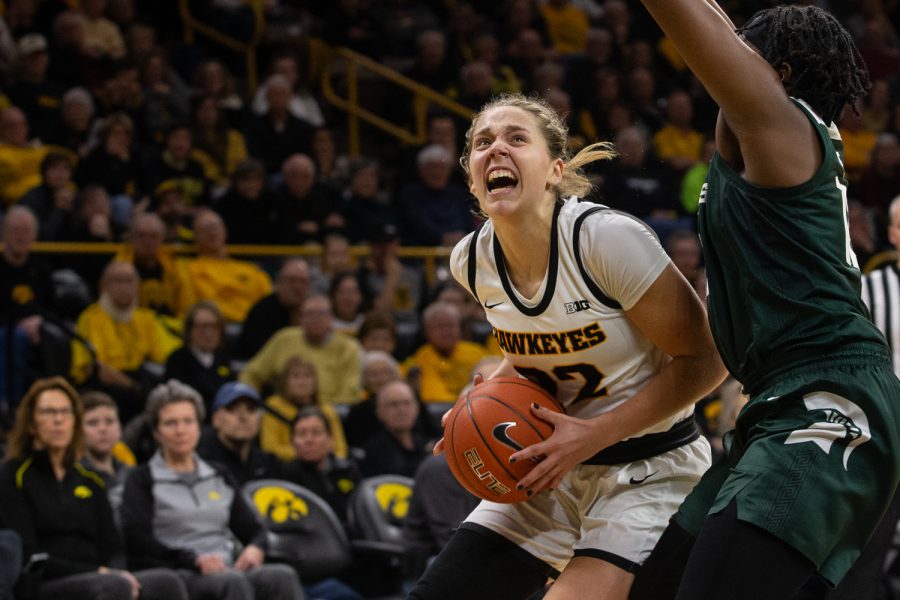 Iowa guard Kathleen Doyle looks to shoot the ball while being blocked by Michigan State forward Nia Hollie during the Iowa women's basketball game against Michigan State University on Sunday, Jan. 26, 2020 at Caver-Hawkeye Arena. The Hawkeyes defeated the Spartans, 74-57, 20 points of which were scored by Doyle. 