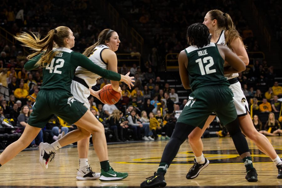 Iowas+McKenna+Warnock+attempts+to+keep+the+ball+away+from+Michigan+State+forward+Kayla+Belles+during+the+Iowa+womens+basketball+game+against+Michigan+State+University+on+Sunday%2C+Jan.+26%2C+2020+at+Caver-Hawkeye+Arena.+The+Hawkeyes+defeated+the+Spartans%2C+74-57.+Warnock+led+the+Hawkeyes+in+scoring+with+22+points.+