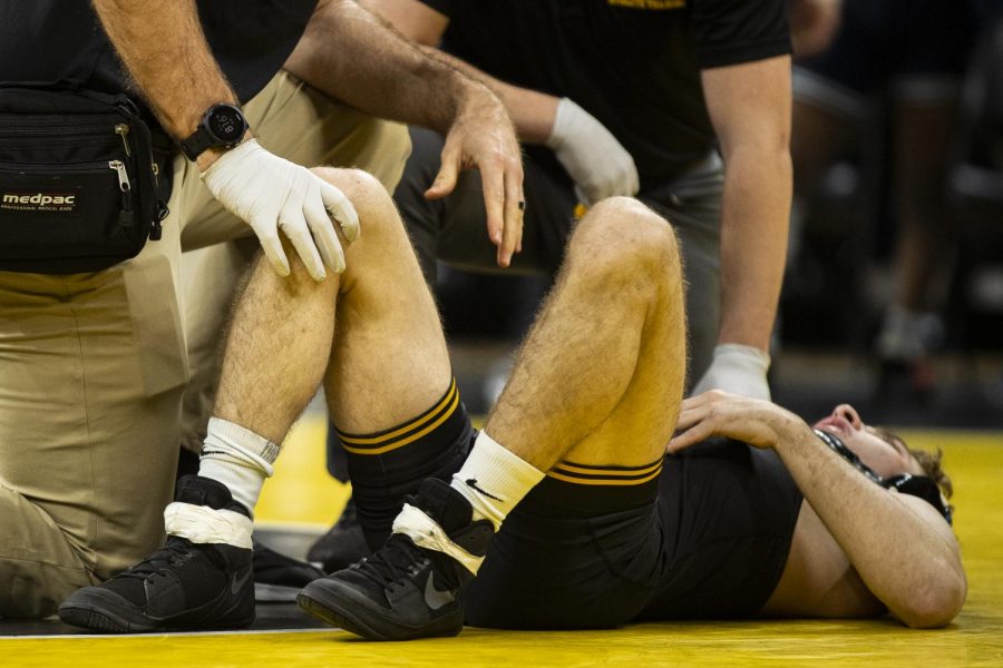 Iowas Austin DeSanto lays injured during a bout against Penn States Roman Bravo-Young during a wrestling dual meet between No. 1 Iowa and No. 2 Penn State at Carver-Hawkeye Arena on Friday, Jan. 31, 2020. (Shivansh Ahuja/The Daily Iowan)