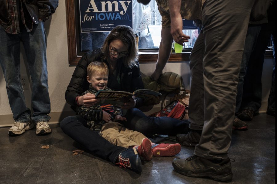 Mary Kosloski reads with her son Felix during an office opening event for Senator Amy Klobuchar, D-Minn. in Iowa City on Dec. 28.