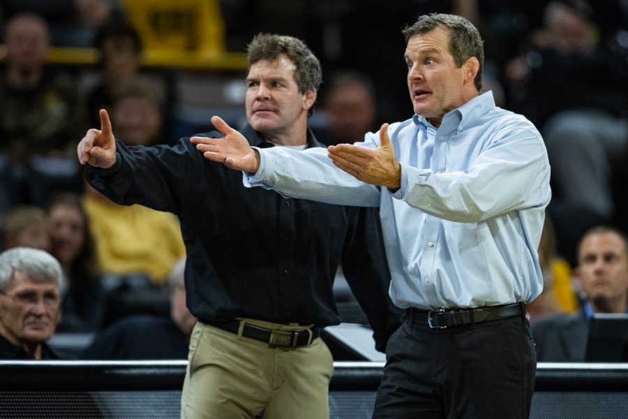 Iowa coaches Terry (left) and Tom Brands gesture toward the officials during a wrestling dual meet between Iowa and Nebraska at Carver-Hawkeye Arena on Saturday, Jan. 18, 2020. The Hawkeyes defeated the Huskers, 26-6.