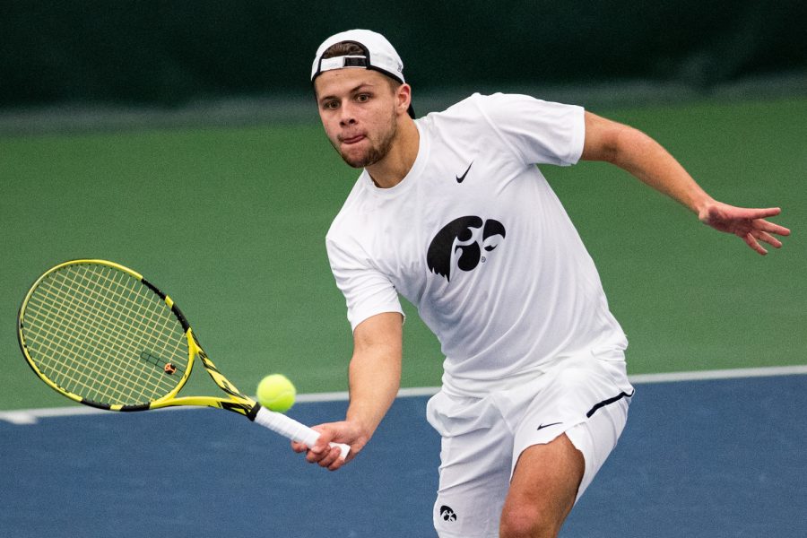 Iowas Will Davies hits a volley during a mens tennis match between Iowa and Western Michigan at the HTRC on Saturday, Jan. 18, 2020. The Hawkeyes defeated the Broncos, 4-3.