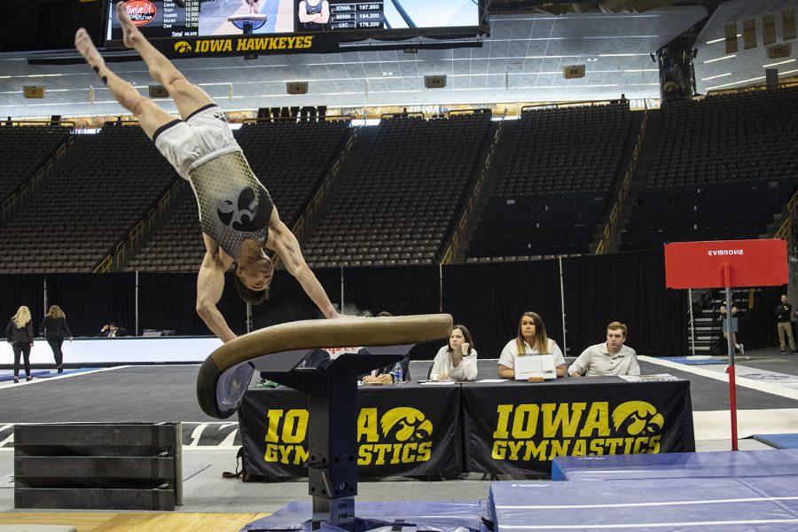 Iowa’s Brandon Wong performs on the vault during a Men’s gymnastics meet against The University of Minnesota and the University of Illinois at Chicago. The Hawkeyes won with a final team score of 400.00. Wong received a score of 14.100 for his vault. 