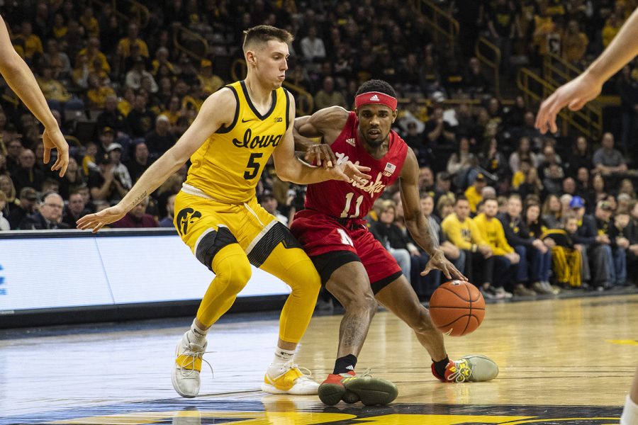 Iowa guard CJ Fredrick attempts to block Nebraska guard Dachon Burke Jr. during a men’s basketball game between the Iowa Hawkeyes and the Nebraska Huskers at Carver-Hawkeye arena on Saturday, February 8, 2020. The Hawkeyes defeated the Huskers 96-72.