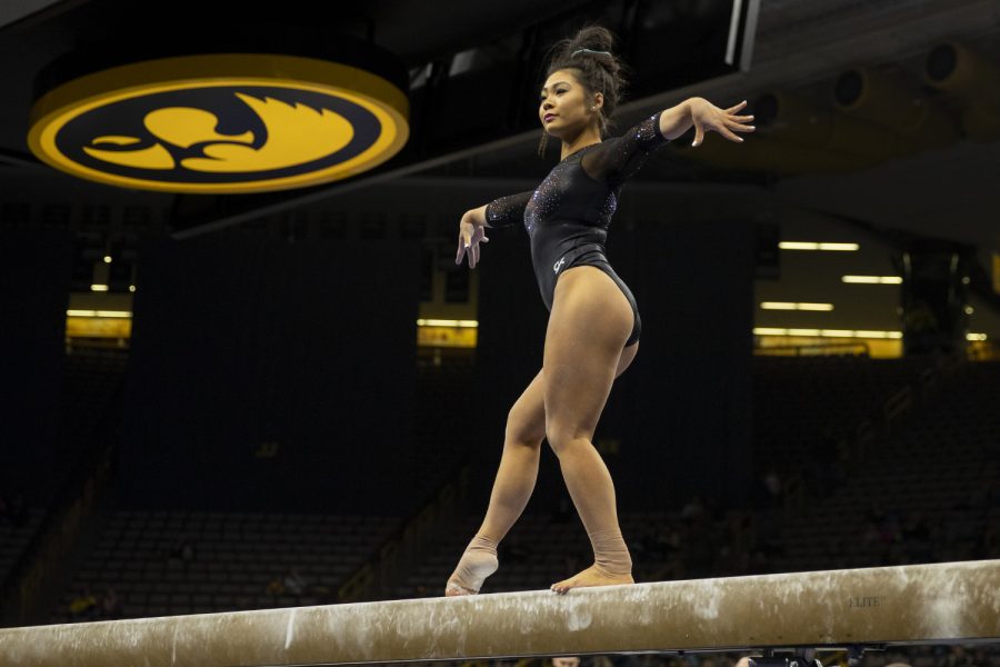 Iowa’s Clair Kaji performs on the beam during a gymnastics meet between Iowa and Michigan at Carver Hawkeye Arena on Friday, Feb. 14, 2020. The GymHawks were defeated by the Wolverines with a score, 195.975-196.800. Kaji earned a score of 9.850. 